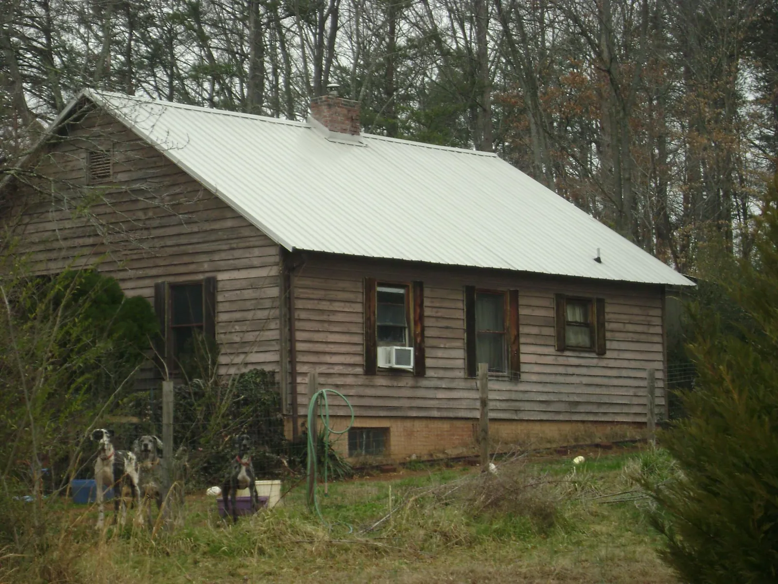 White metal roof on an old wood sided farmhouse, from a Metal Roof Installation job in Cologne